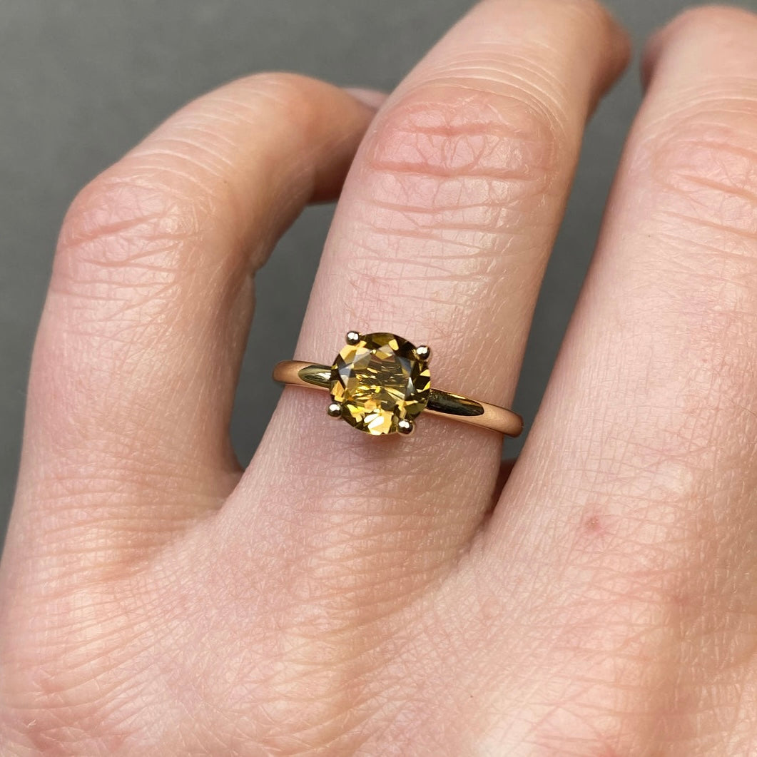 brown tourmaline gold ring on hand