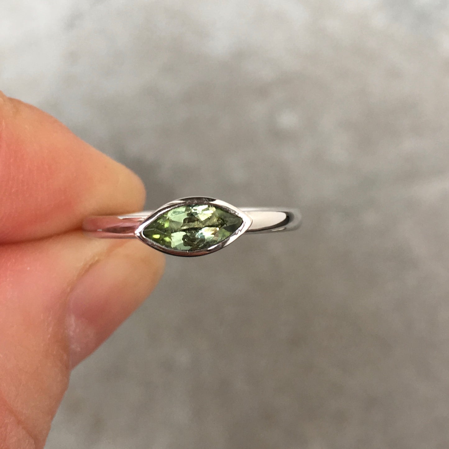 14k white gold ring set with an olive green tourmaline