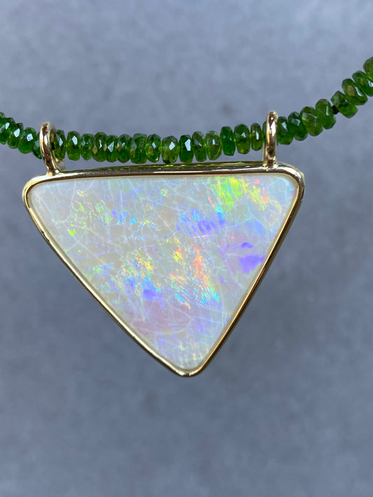 Opal pendant in yellow gold with a tsavorite necklace