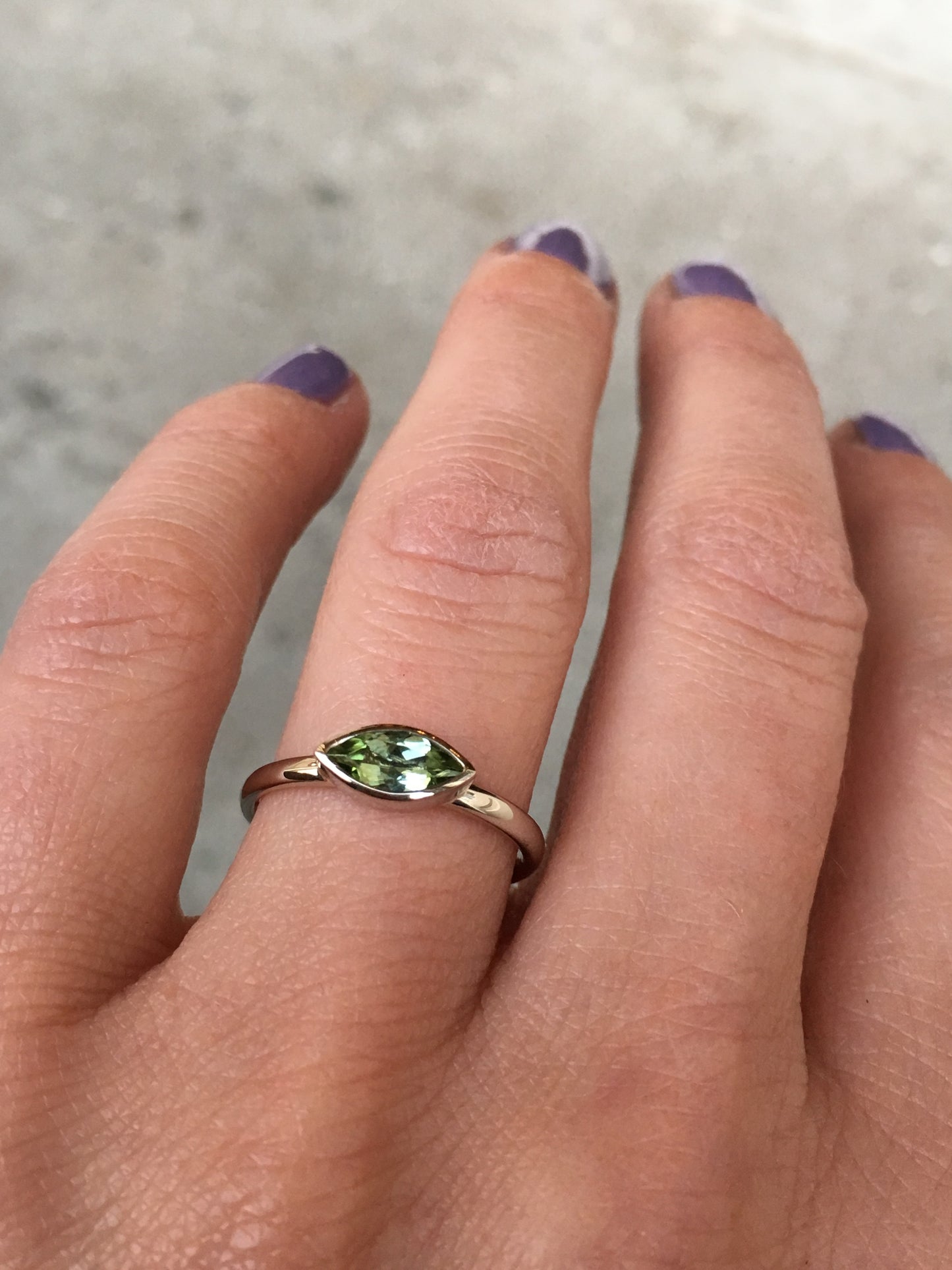 14k white gold ring set with an olive green tourmaline
