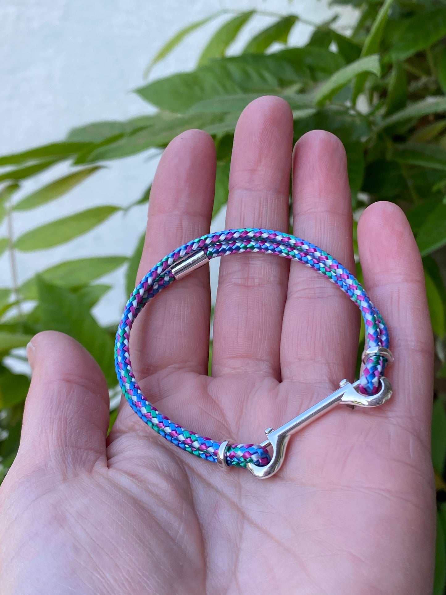 looped bracelet with siver double clasp on hand
